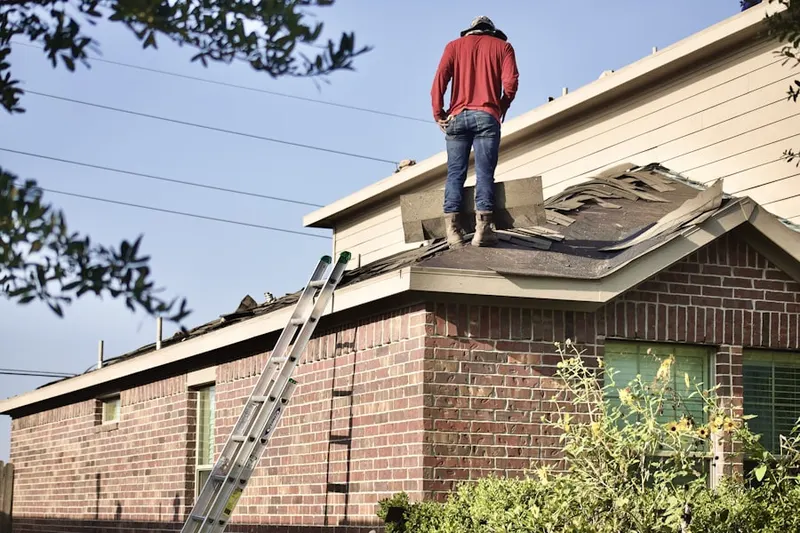 Professional roofer working on a residential roof in Fairfax
